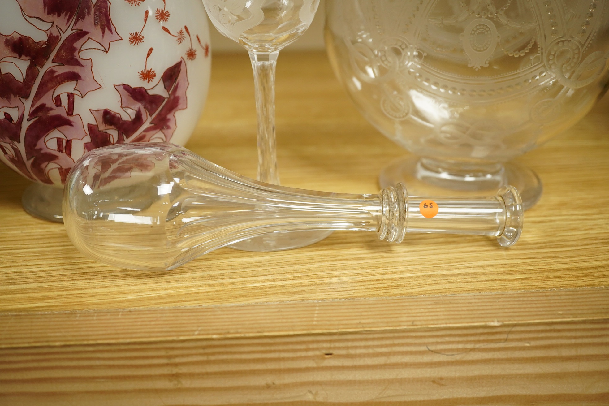 A Continental Art Nouveau glass carafe enamelled with flowers, an English wine glass engraved with the symbols of the Union, a Victorian engraved claret jug and a toddy lifter. Condition - carafe has some occasional scra